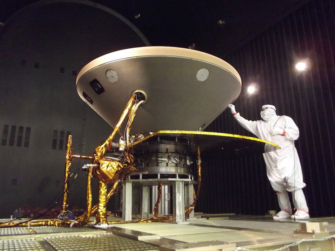 (NASA/JPL-Caltech/Lockheed Martin via The Associated Press) In this 2015 photo made available by NASA, a technician prepares the InSight spacecraft for thermal vacuum testing in its "cruise" configuration for its flight to Mars, simulating the conditions of outer space at Lockheed Martin Space Systems in Denver. NASA’s three-legged, one-armed geologist known as InSight makes its grand entrance through the rose-tinted Martian skies on Monday, Nov. 26, 2018.