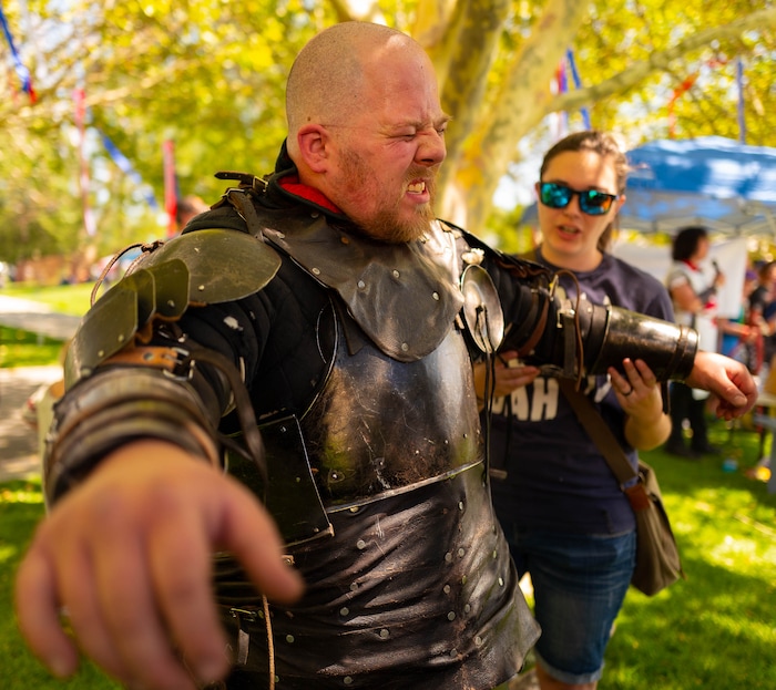 (Trent Nelson  |  The Salt Lake Tribune)  Justice Cluff, known as the Dwarf King, works out some pain in his shoulder after being hit with a two-handed sword in competition put on by the Armored Combat League at the Utah Renaissance Faire at Thanksgiving Point in Lehi on Friday Aug. 23, 2019. At right is Jenesey Cox.