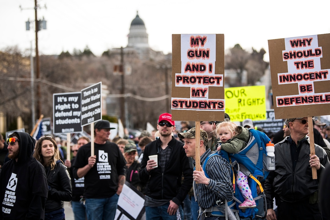 (Chris Detrick | The Salt Lake Tribune)  Participants hold signs during the March Before Our Lives rally near West High School in Salt Lake City Saturday, March 24, 2018.