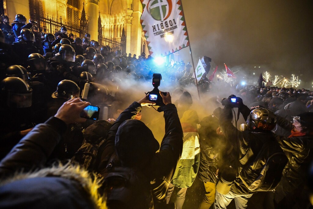 Protesters clash with police during a demonstration against the amendments to the labour code, dubbed "slave law" by oppositional forces, at the parliament building in Budapest, Hungary, Dec. 13, 2018. The rally, which was announced by the Free University and Students Trade Union student groups, started peacefully but police later responded to aggressive protestors with teargas. (Marton Monus/MTI via AP)