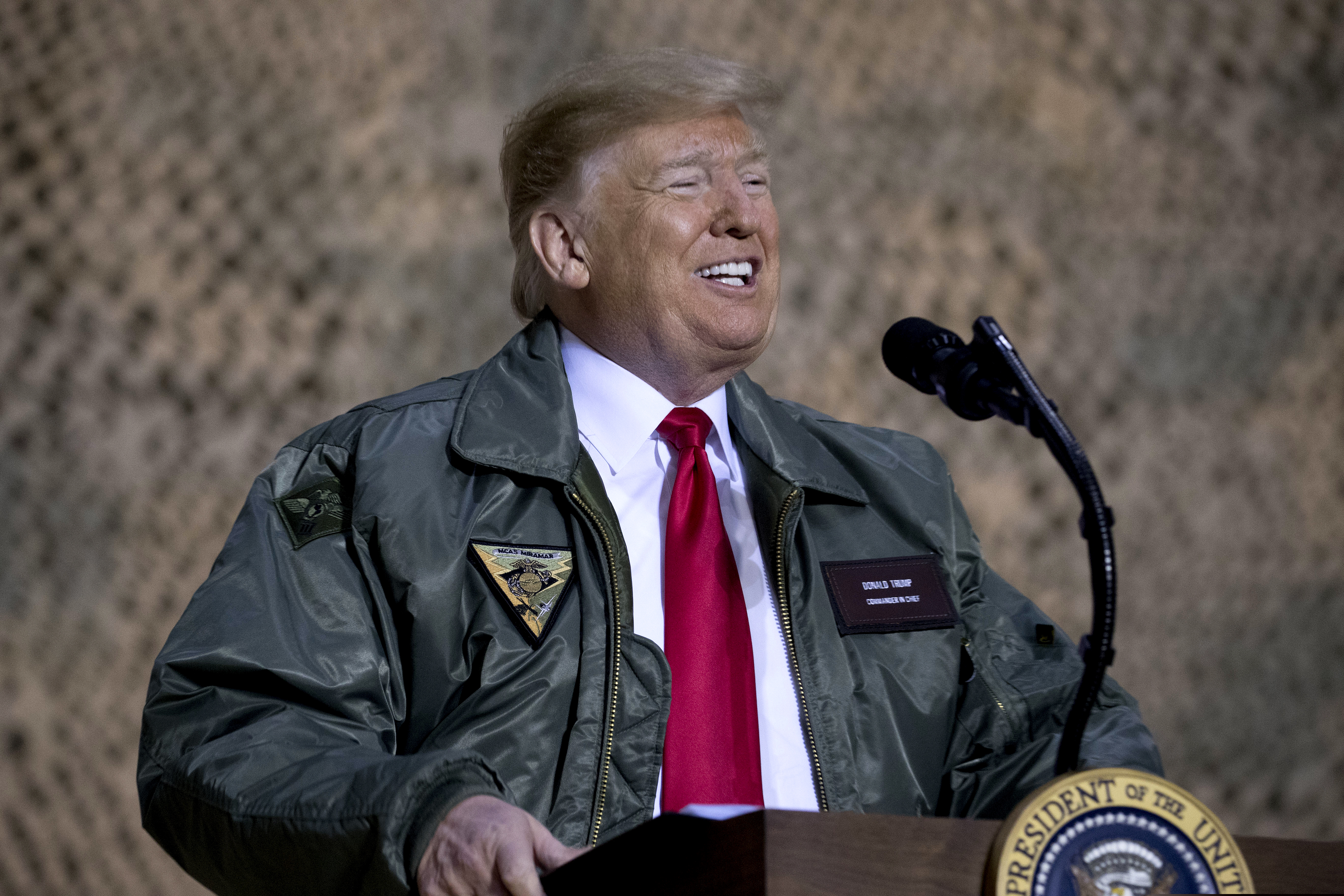 President Donald Trump speaks at a hangar rally at Al Asad Air Base, Iraq, Wednesday, Dec. 26, 2018. President Donald Trump, who is visiting Iraq, says he has 'no plans at all' to remove US troops from the country. (AP Photo/Andrew Harnik)