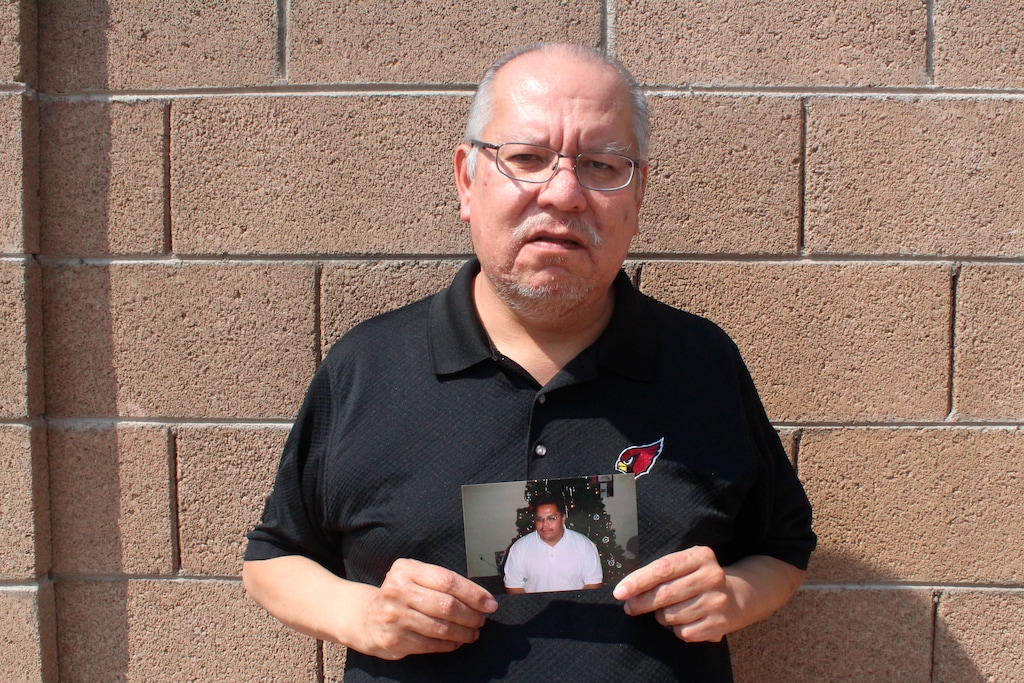 (Jonathan J. Cooper | AP) Auska Mitchell holds a photograph of his nephew, Lezmond Mitchell, on Friday, Aug. 21, 2020 in Goodyear, Ariz. Lezmond Mitchell is scheduled to be executed Wednesday, Aug. 26, and the Navajo government is pushing to spare his life on the basis of cultural beliefs and sovereignty.