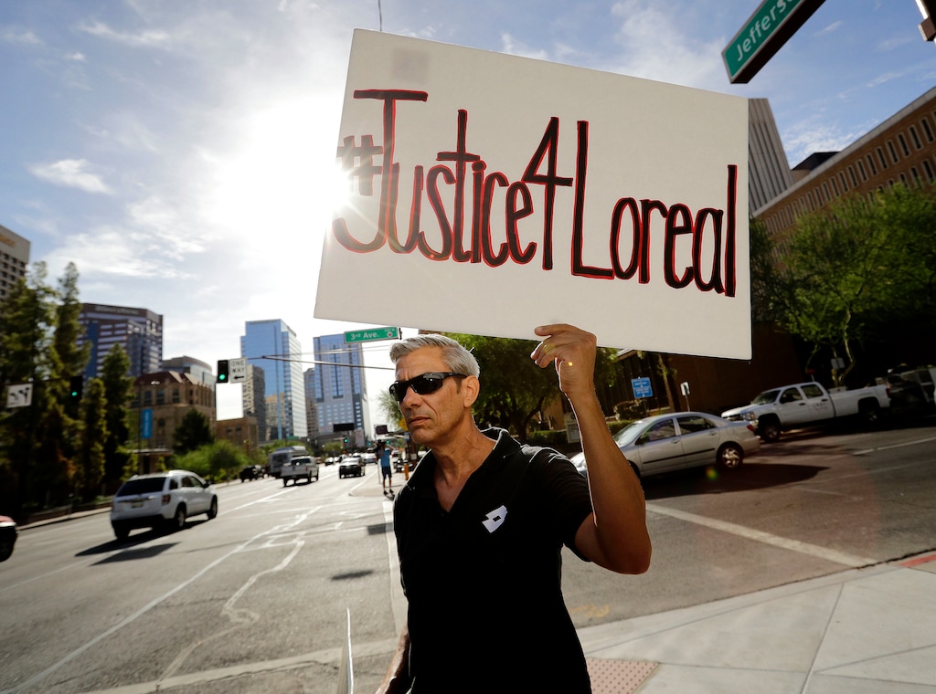 (Matt York | The Associated Press) In this Monday, July 25, 2016 file photo, Chris Fleischman protests outside Maricopa County Attorney Bill Montgomery's office in Phoenix. Loreal Tsingine, a Navajo woman who was fatally shot by an Arizona police officer earlier this year, had medical scissors in her hand as she approached the lawman, body camera video released Wednesday shows. The shooting led tribal officials to urge the U.S. Justice Department to investigate the treatment of American Indians who live in towns bordering the reservation.