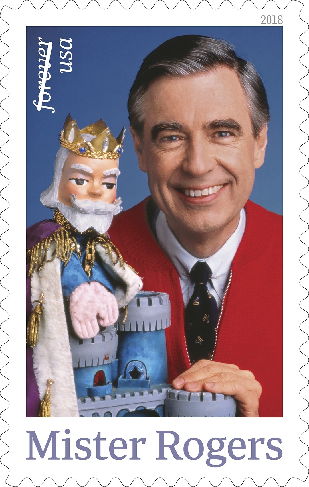 This image released by the United States Postal Service shows a postage stamp featuring Fred Rogers from the PBS children's television series "Mister Rogers' Neighborhood" with his King Friday XIII puppet. The U.S. Postal Service plans to issue a new stamp on March 23 in the same Pittsburgh public television station where the program was produced. Rogers died in 2003 at 74 after battling stomach cancer. (USPS via AP)