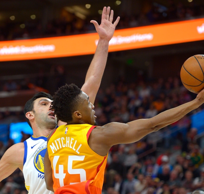 (Steve Griffin  |  The Salt Lake Tribune) Utah Jazz guard Donovan Mitchell (45) gets past Golden State Warriors center Zaza Pachulia (27) for two points during the Utah Jazz versus Golden State Warriors at Vivint Smart Home Arena in Salt Lake City Tuesday January 30, 2018.