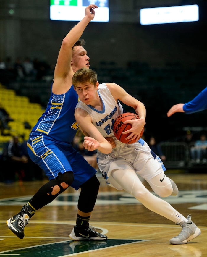 (Steve Griffin  |  The Salt Lake Tribune) Layton's Chase Potter tucks the ball and runs past Cyprus defender Skyler Case during 6A basketball playoff game at the Utah Valley UniversityÕs UCCU Center in Provo Tuesday Feb. 27, 2018.
