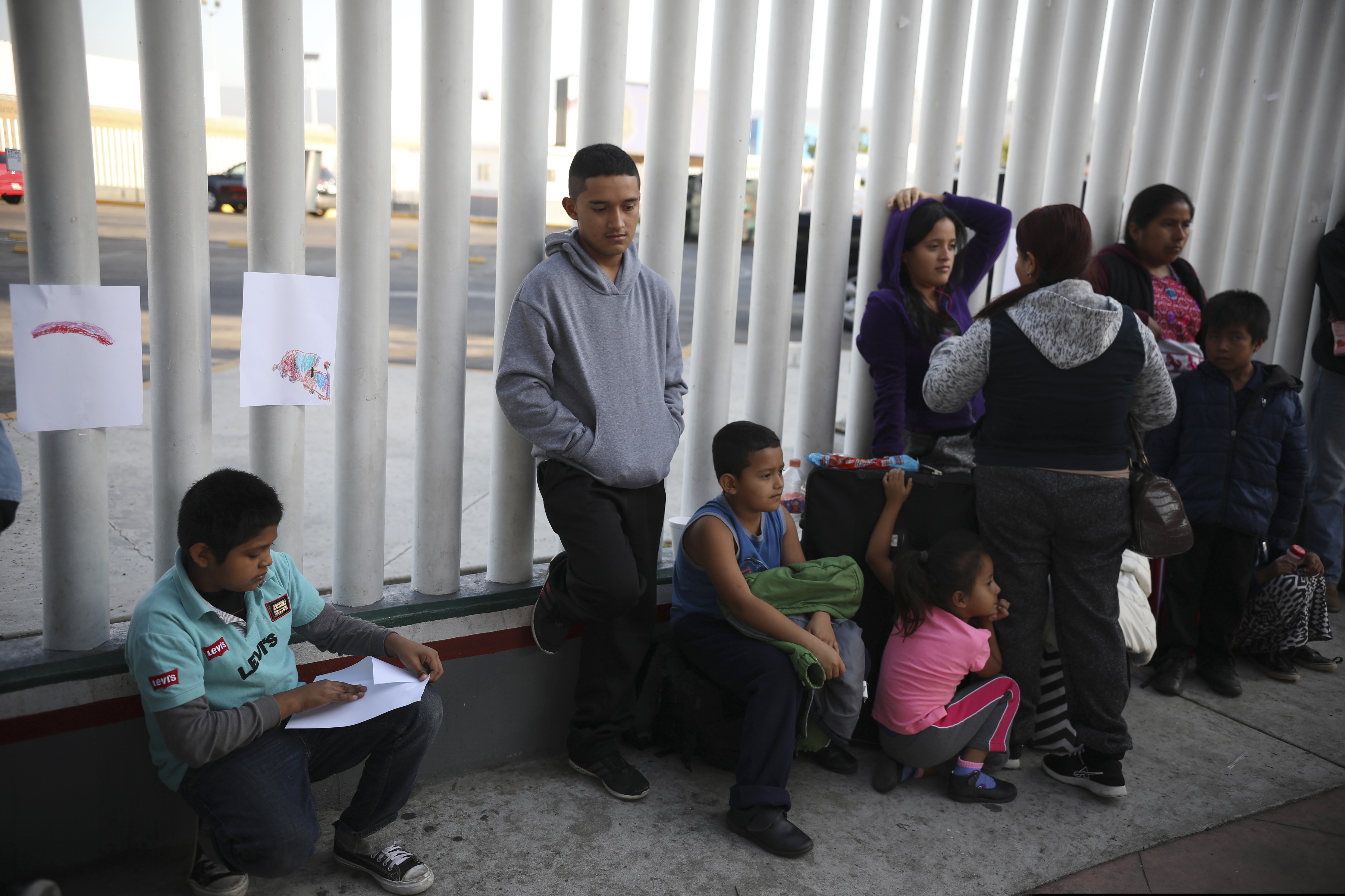 FILE - In this Sept. 13, 2019, file photo, Central American migrants wait to see if their number will be called to cross the border and apply for asylum in the United States, at the El Chaparral border crossing in Tijuana, Mexico. Thousands of people are waiting to claim asylum and more come each day, falsely believing they will be able to enter the U.S. now that former President Donald Trump is out of office. While President Joe Biden has taken some major steps in his first weeks in office to reverse Trump's hardline immigration policies, his administration hasn't lifted some of the most significant barriers to asylum-seekers. (AP Photo/Emilio Espejel, File)