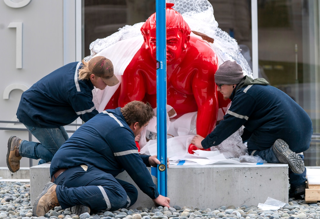 (Rick Egan | The Salt Lake Tribune)  Workers place a new art installation featuring a life-size sumo wrestler, in front of the Mountain West Commercial Real Estate building, previously the KALL Radio 910 broadcast station, on South Temple, in Salt Lake City, on Monday, March 29, 2021