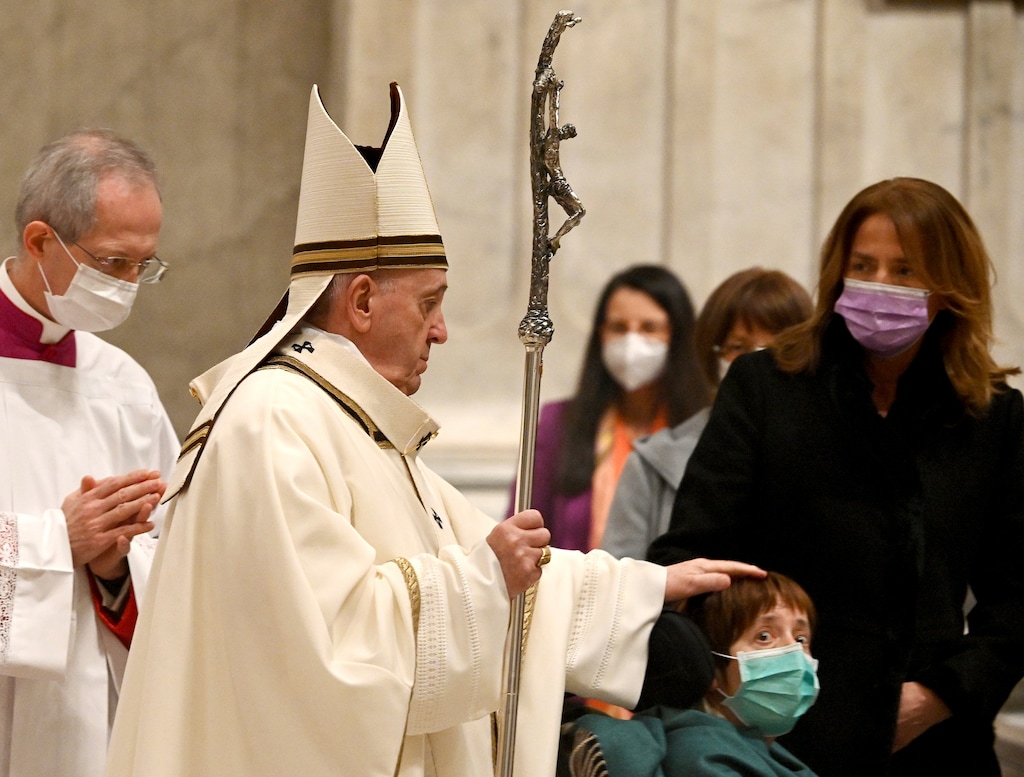 (Vincenzo Pinto | Pool via AP) Pope Francis caresses a boy as he arrives to celebrate Mass on Christmas eve, at St. Peter's basilica at the Vatican, Thursday, Dec. 24, 2020.