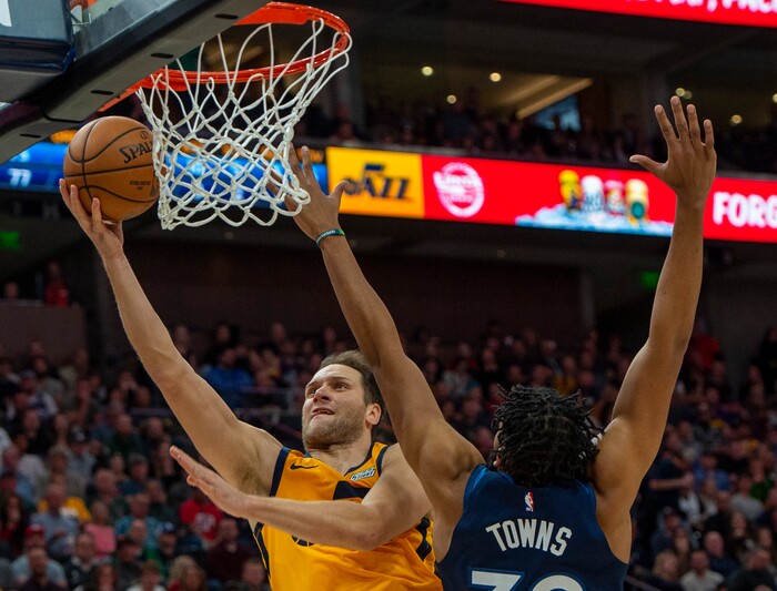 (Rick Egan  |  The Salt Lake Tribune)     Utah Jazz forward Bojan Bogdanovic (44) scores as Minnesota Timberwolves center Karl-Anthony Towns (32) defends, in NBA action between the Utah Jazz and the Minnesota Timberwolves in Salt Lake City, Monday, Nov. 18, 2019.