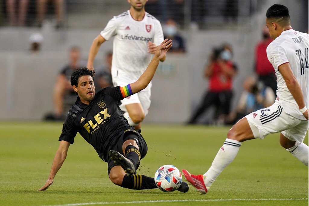 Los Angeles FC forward Carlos Vela, left, dives for the ball as Real Salt Lake forward Rubio Rubin reaches for it during the first half of a Major League Soccer match Saturday, July 17, 2021, in Los Angeles. (AP Photo/Mark J. Terrill)