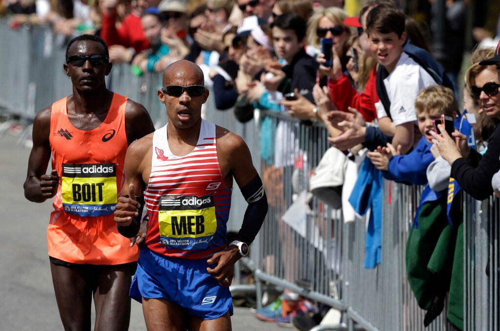FILE - In this April 21, 2014 file photo, Meb Keflezighi leads Josphat Boit along the course of the 118th Boston Marathon in Boston. Keflezighi said he'll hang up his racing shoes for good after running the April 17, 2017, Boston Marathon and the TCS New York City Marathon in November. (AP Photo/Steven Senne, File)