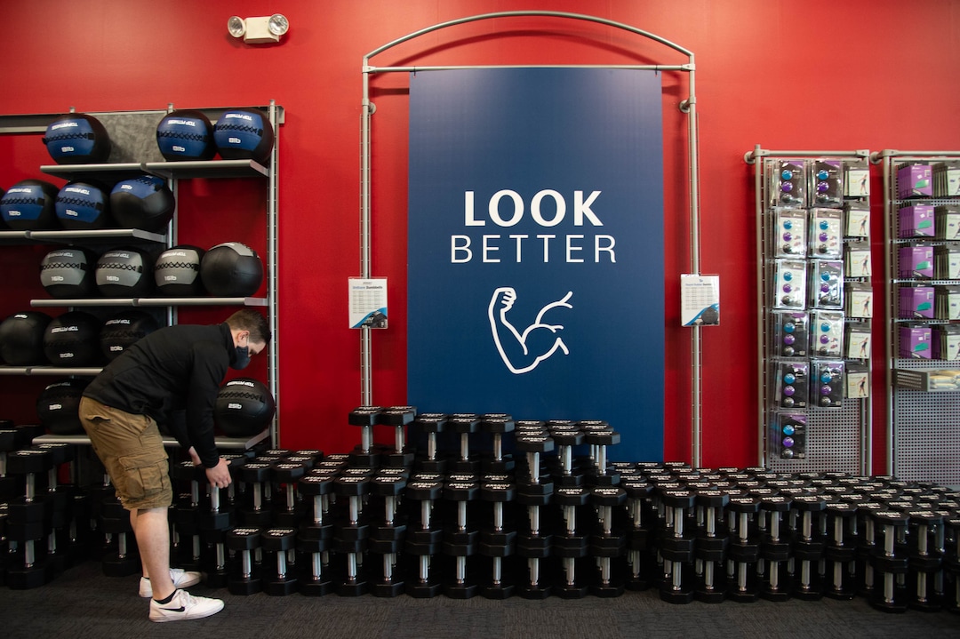 (Francisco Kjolseth  |  The Salt Lake Tribune) Chase Buckles, sales manager at Utah Home Fitness in Sandy, takes advantage of a slow moment to catch up on restocking inventory on Wednesday, Oct. 22, 2020. Home fitness equipment sales boomed in March and April when gyms closed because of the coronavirus. Everything from inexpensive dumbbells to premium treadmills and ellipticals were wiped out of stores and warehouses. Record sales continue throughout the summer — normally the slow time for the industry, and store owners expect sales to remain high during the holidays.