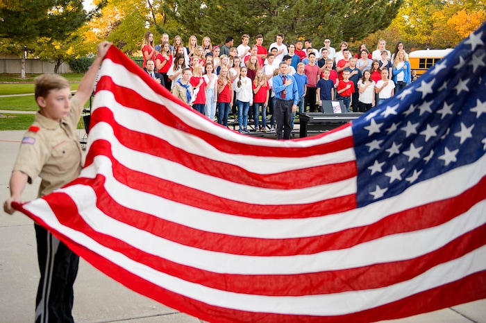 (Trent Nelson | The Salt Lake Tribune)
Students in the South Jordan Middle School Concert Choir look on as boy scouts raise the flag at sunrise to mark the anniversary of 9/11, Tuesday Sept. 11, 2018.