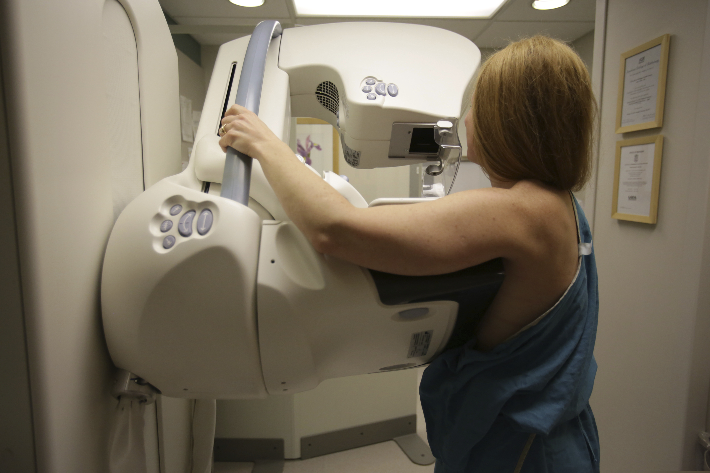 FILE - In this May 22, 2015 photo, a woman gets a mammogram at the University of Michigan Cancer Center in Ann Arbor, Mich.   (Kimberly P. Mitchell/Detroit Free Press via AP, File)