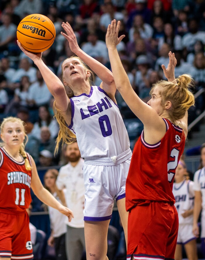 (Rick Egan | The Salt Lake Tribune) Lehi Pioneer center,Tara Smith (0) shoots, as Springville Red Devils, Brooke Pennington (2) defends, in the girls 5A State Championship game between the Springville Red Devils and the Lehi Pioneers, at the Marriott Center in Provo, on Saturday, March 5, 2022. 
