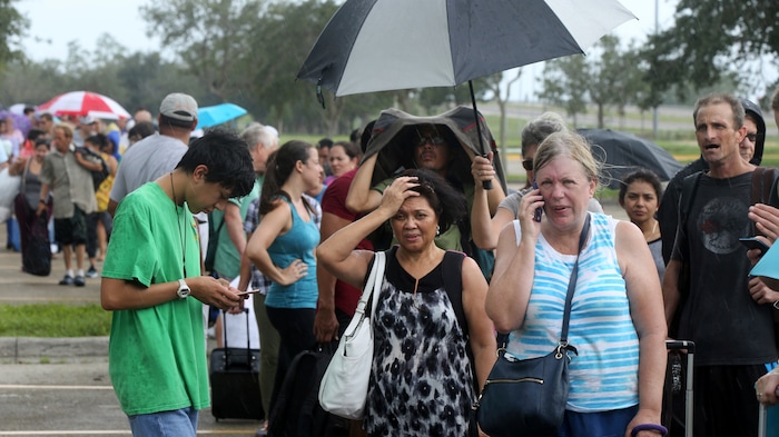 (AP Photo/Gerald Herbert) Evacuees stand in line to enter the Germain Arena, which is being used as a fallout shelter, in advance of Hurricane Irma, in Estero, Fla., Saturday, Sept. 9, 2017.