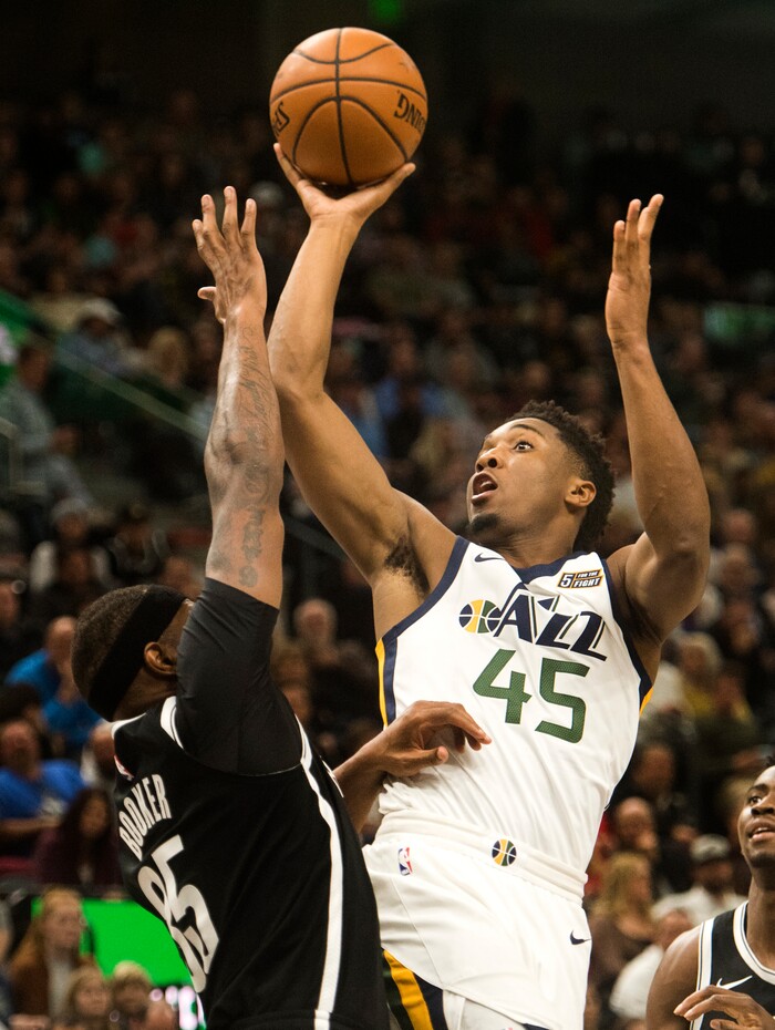 (Rick Egan  |  The Salt Lake Tribune)  Utah Jazz guard Donovan Mitchell (45) shoots over Brooklyn Nets forward Trevor Booker (35), in NBA action, Utah Jazz vs. Brooklyn Nets, in Salt Lake City, Saturday, November 11, 2017.