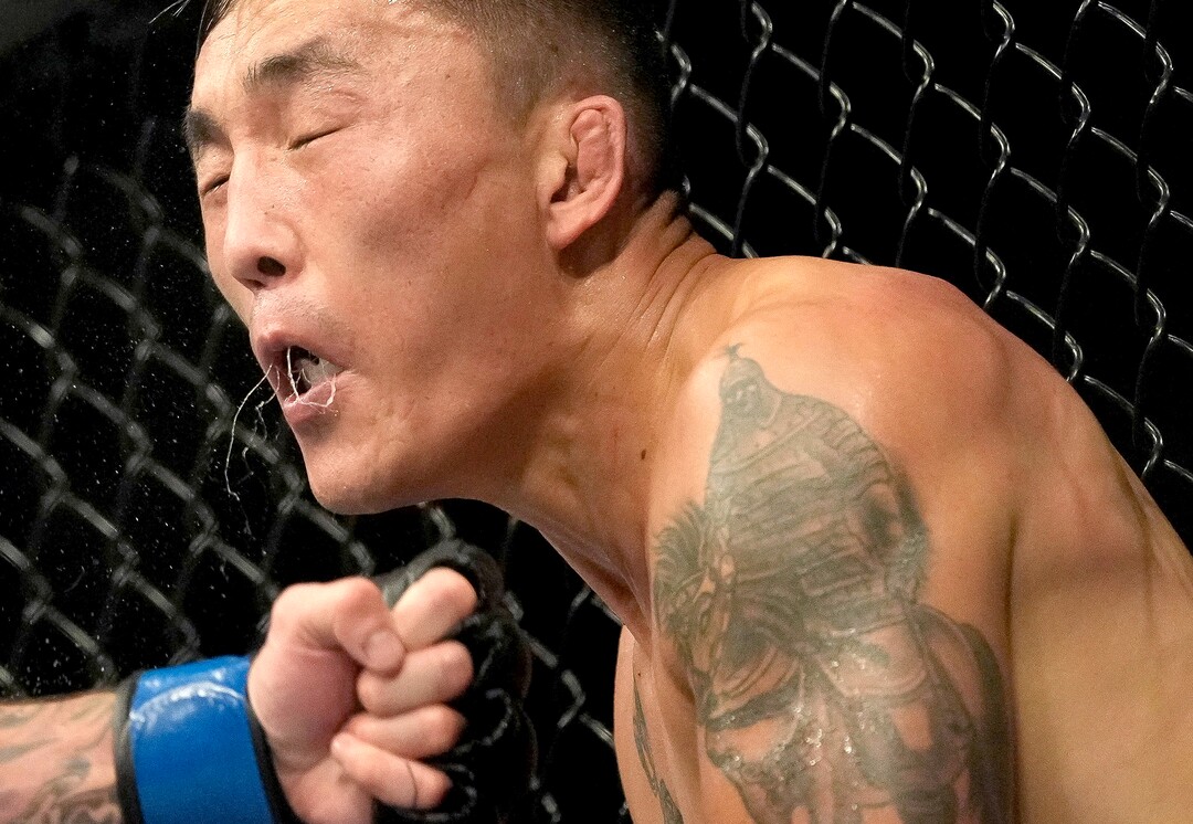 (Francisco Kjolseth | The Salt Lake Tribune) Aoriqileng of China takes a hit from Jay Perrin of the United States during their bantamweight bout at Vivint Arena for UFC 278 on Saturday, Aug. 20, 2022. 