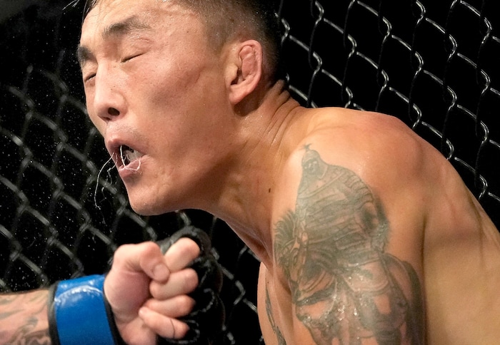 (Francisco Kjolseth | The Salt Lake Tribune) Aoriqileng of China takes a hit from Jay Perrin of the United States during their bantamweight bout at Vivint Arena for UFC 278 on Saturday, Aug. 20, 2022. 