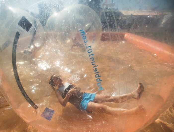 (Rick Egan  |  The Salt Lake Tribune)   Tesla Thomas, 9 of American Fork, rested in side a giant plastic bubble, at the Utah State Fair, Sunday, September 10, 2017.


