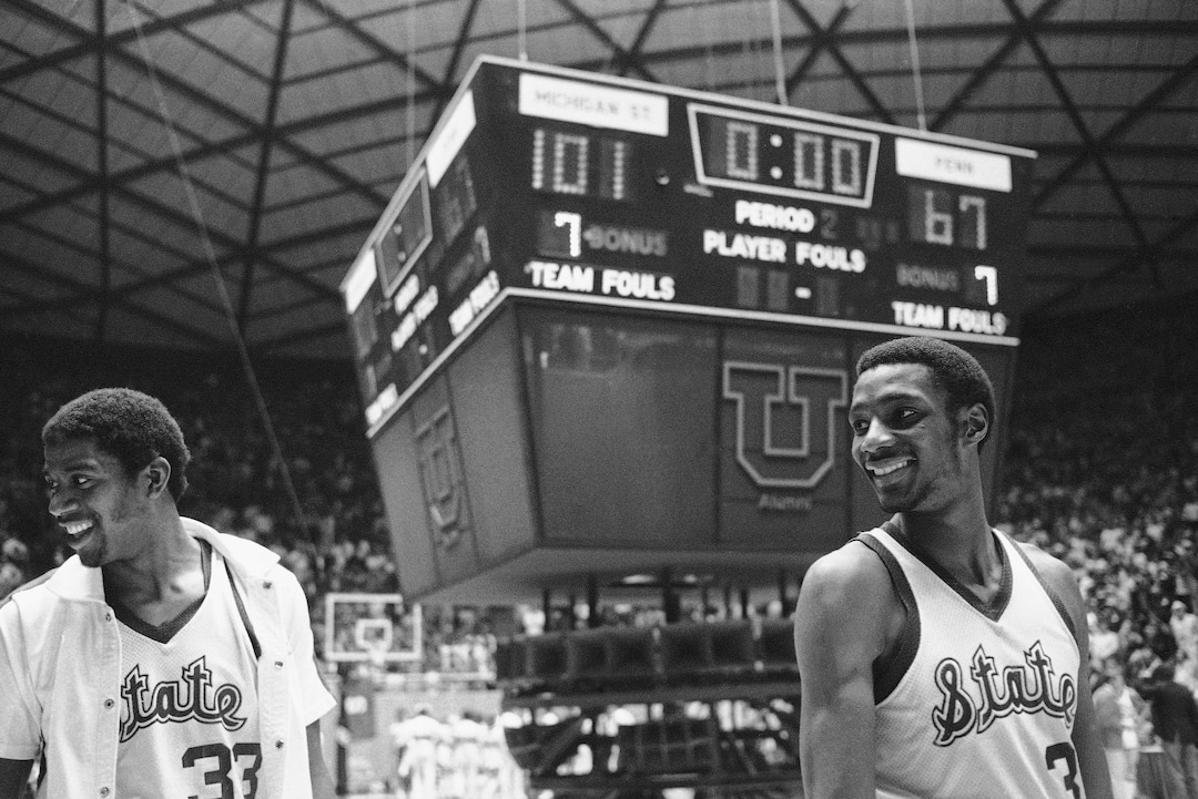 (AP Photo) Michigan State stars Earvin Johnson (33) and Gregory Kelser (32) are all smiles and the scoreboard tells why, Saturday, March 24, 1979 in Salt Lake City after their team defeated Pennsylvania 101-67 to advance to the finals of the NCAA Championships. (