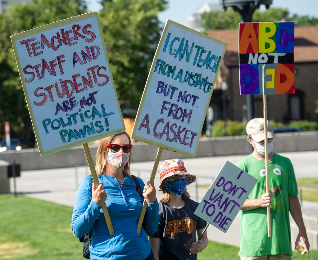 (Rick Egan  |  The Salt Lake Tribune)     Protesters social-distance on the lawn as they listen to speakers, during a Mask-In and Car Caravan protest at the State Capitol to demand the governor and other state local leaders ensure Utah schools protect students and staff when schools reopen. Thursday, July 23, 2020.