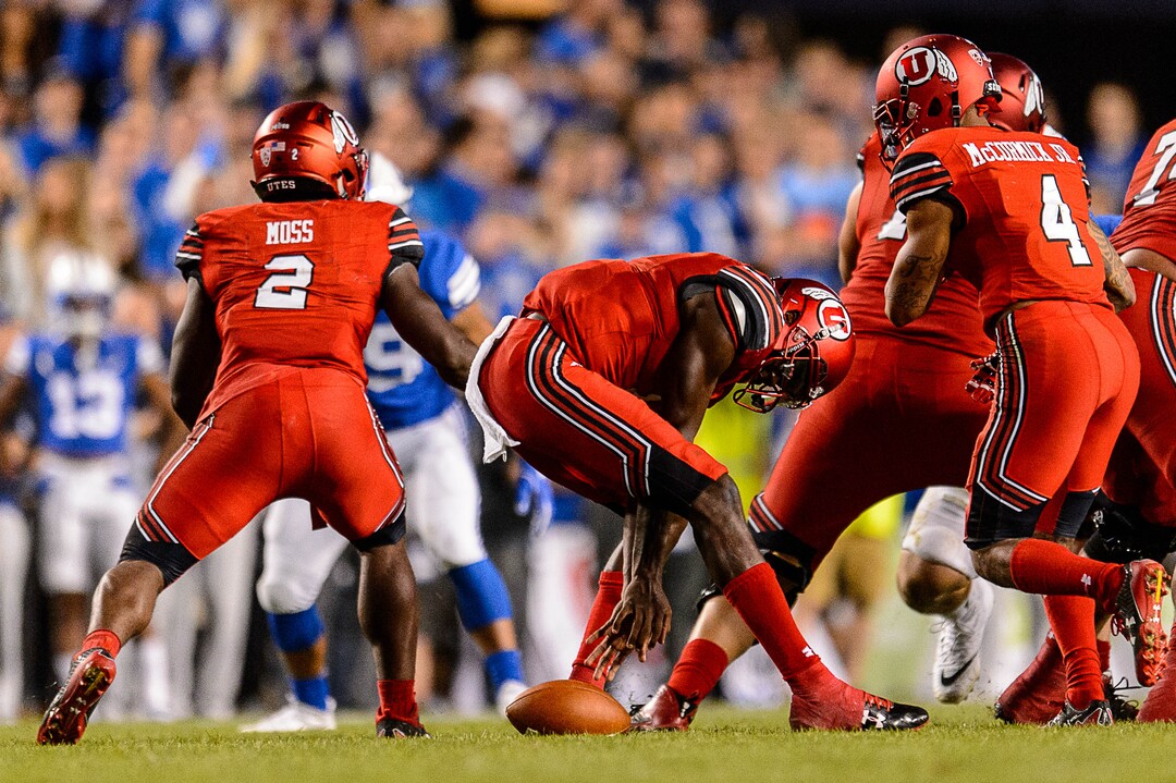 (Trent Nelson | The Salt Lake Tribune)  Utah Utes quarterback Tyler Huntley (1) reaches for a ball he's dropped as BYU hosts Utah, NCAA football in Provo, Saturday September 9, 2017.