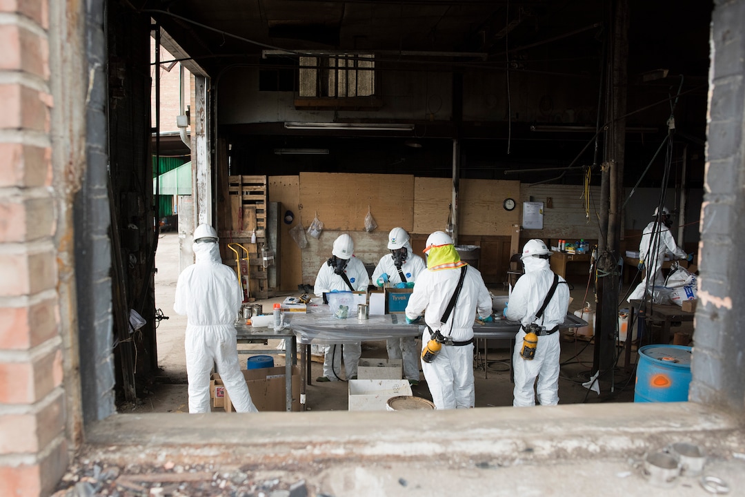 (Briana Scroggins  |  The Utah Investigative Journalism Project) Windows were knocked out and doors are kept open so EPA Contractors can open samples for testing in a well ventilated area near the Swift building in Ogden on Thursday, May 16, 2019. The EPA started site clean up on April 1 and plan to finish by August 2019.