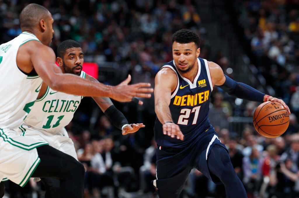 Denver Nuggets guard Jamal Murray, right, drives the lane as Boston Celtics center Al Horford, left, and guard Kyrie Irving, center, defend in the first half of an NBA basketball game Monday, Nov. 5, 2018, in Denver. (AP Photo/David Zalubowski)