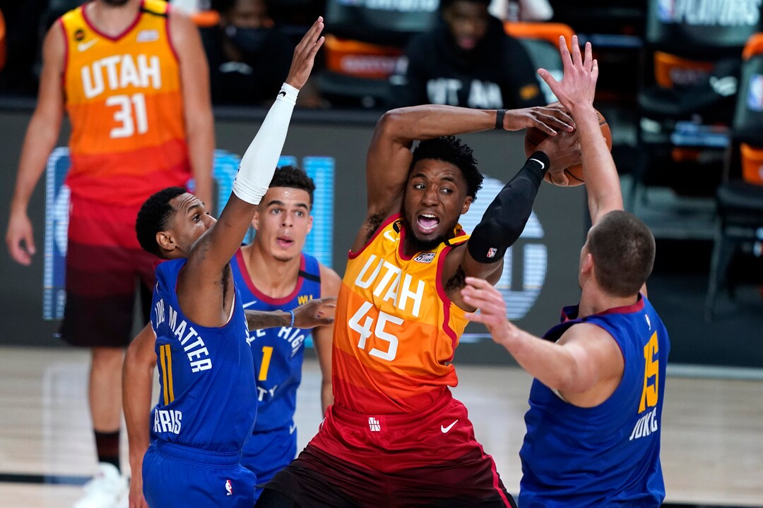 Utah Jazz's Donovan Mitchell (45) loses the ball as Denver Nuggets' Monte Morris (11) and Nikola Jokic (15) defend during the first half of an NBA basketball first round playoff game Sunday, Aug. 30, 2020, in Lake Buena Vista, Fla. (AP Photo/Ashley Landis)