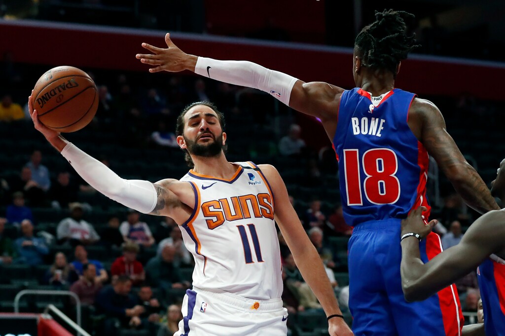 Phoenix Suns guard Ricky Rubio (11) passes as Detroit Pistons guard Jordan Bone (18) defends during the first half of an NBA basketball game, Wednesday, Feb. 5, 2020, in Detroit. (AP Photo/Carlos Osorio)