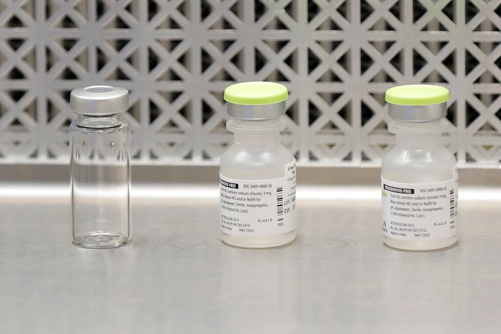 FILE - This March 16, 2020 file photo shows vials used by pharmacists to prepare syringes used on the first day of a first-stage safety study clinical trial of the potential vaccine for COVID-19, the disease caused by the new coronavirus, at the Kaiser Permanente Washington Health Research Institute in Seattle. In early April 2020, the World Health Organization counted more than five dozen vaccine candidates being pursued around the world. (AP Photo/Ted S. Warren)