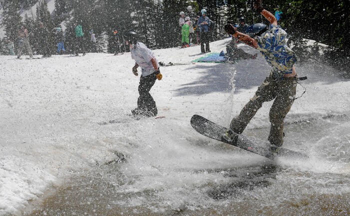 (Francisco Kjolseth  | The Salt Lake Tribune) A party atmosphere forms at the pond in Peruvian Gulch as Snowbird closes the book on the 2024-25 ski season on Monday, May 26, 2025. Snow and sun revelers took to the slushy slopes on Memorial Day as the resort was the last in the state to close.