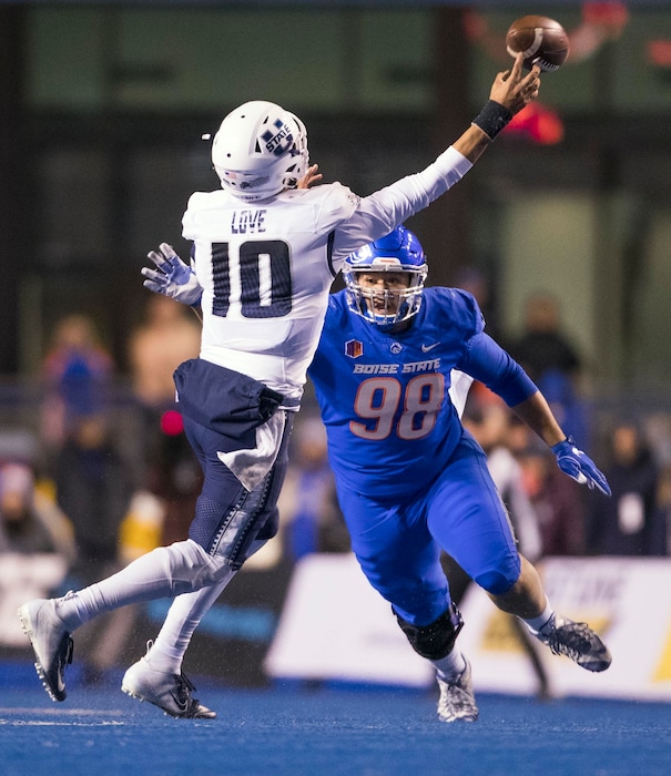 (Darin Oswald/Idaho Statesman via AP) Boise State nose tackle Sonatane Lui (98) puts pressure on Utah State quarterback Jordan Love (10) during the second quarter of an NCAA college football game Saturday, Nov. 24, 2018, in Boise, Idaho.