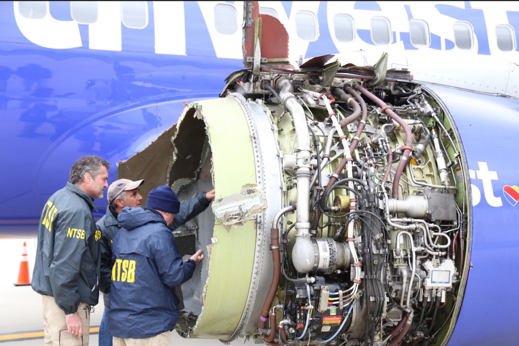 NTSB investigators examine damage to the engine of the Southwest Airlines plane that made an emergency landing in Philadelphia on Tuesday. (Courtesy of NTSB)