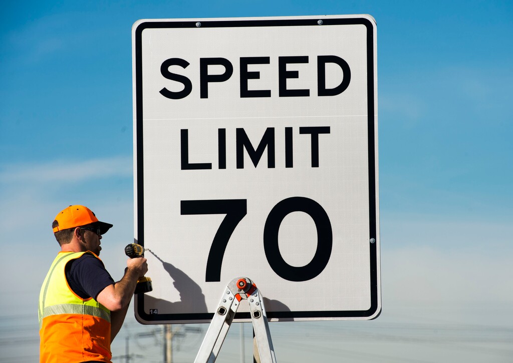 Steve Griffin | The Salt Lake Tribune
UDOT's Stephan Foster installs a new 70 mph speed limit sign over a 65 mph sign on I-80 near 5600 West in Salt Lake City, Monday, Dec. 8, 2014.