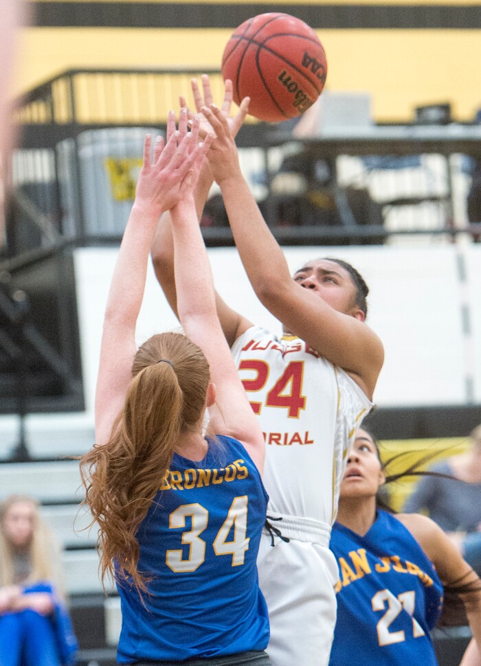 (Rick Egan  |  The Salt Lake Tribune)    Judge Memorial guard Miyalla Tarver (24) takes a shot, as Delaney Palmer (34) defends, in 3A Women's basketball State playoff action Judge Memorial Vs. San Juan, in Heber City, Friday, Feb. 16, 2018.