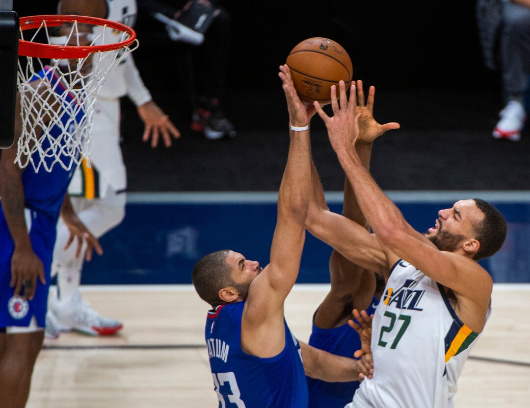 (Rick Egan | The Salt Lake Tribune) Utah Jazz center Rudy Gobert (27) goes to the basket, as LA Clippers forward Nicolas Batum (33) defends, from scoring, in NBA action between the Utah Jazz and the LA Clippers at Vivint Arena, on Friday, Jan. 1, 2021.