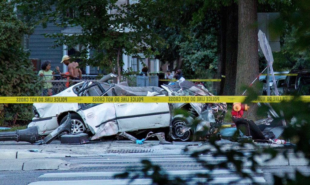 This Friday, July 21, 2017 photo shows a damaged car on the sidewalk after it collided with a bus during a fatal crash in St. Paul, Minn. Authorities filed felony charges Monday, July 24 against Tyler Randall Bjelland whose car sliced through the midsection of a Metro Transit bus on Friday, killing a father of six adult children including a daughter he was supposed to walk down the aisle at her wedding this summer. (Courtney Pedroza/Star Tribune via AP)