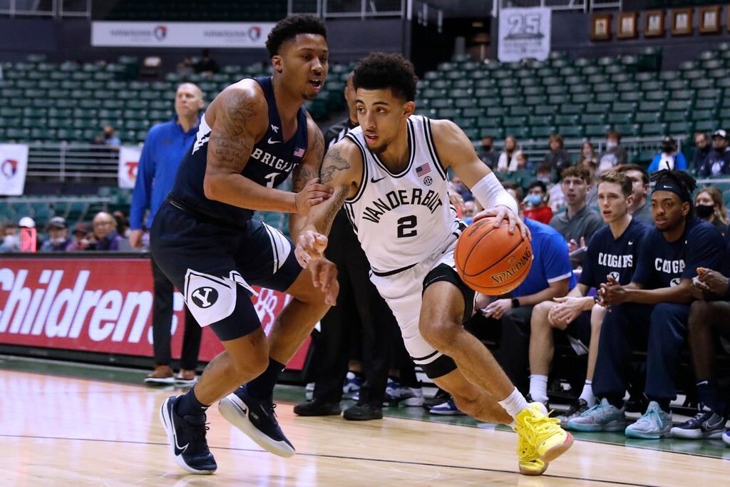 (Marco Garcia | AP) Vanderbilt guard Scotty Pippen Jr. (2) tries to get around BYU guard Te'Jon Lucas during the first half Thursday in Honolulu.