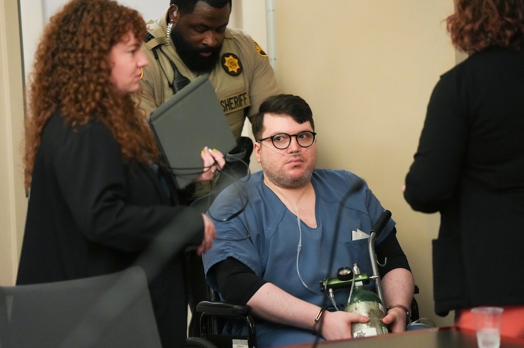 (Bethany Baker | The Salt Lake Tribune) A man who has acknowledged that one of his identities is Nicholas Rossi is wheeled from the courtroom following his preliminary hearing for rape charges at the Salt Lake City District Courthouse in Salt Lake City on Thursday, Aug. 22, 2024. Rossi, accused of rape in Utah in 2008, was extradited from the United Kingdom after a series of hearings in which he claimed to be someone else.