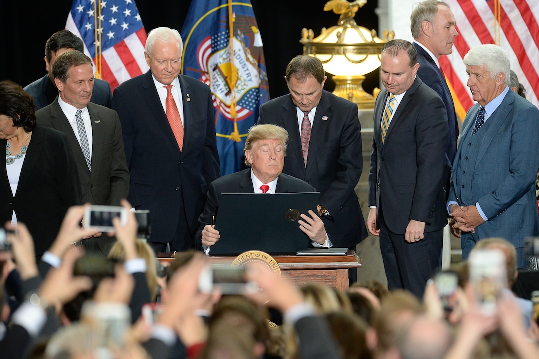 (Francisco Kjolseth  |  The Salt Lake Tribune)  U.S. President Donald Trump is surrounded by Utah representatives at the Utah Capitol on Monday, Dec. 4, 2017, as he signs a presidential proclamation to shrink Bears Ears and Grand Staircase-Escalante national monuments.