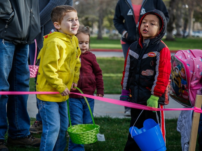 (Nicole Boliaux | For The Tribune) Children and their families wait for the stroke of 9 o'clock to begin the annual Easter egg hunt put on by A Kid's Place Dentistry in Liberty Park in Salt Lake City on Saturday, March 31, 2018.