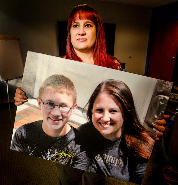 (Steve Griffin | The Salt Lake Tribune) Shari Elliott holds a photo of herself with her son, Avery Kertamus, in her office in South Jordan. The 15-year-old died by suicide in 2013.