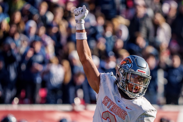 (Trent Nelson  |  The Salt Lake Tribune) Skyridge's Smith Snowden (3) celebrates tackling Corner Canyon's Isaac Wilson (1) with three minutes left in the fourth quarter, effectively ending the game, as Corner Canyon faces Skyridge in the 6A high school football championship game at Rice-Eccles Stadium in Salt Lake City on Friday, Nov. 18, 2022.