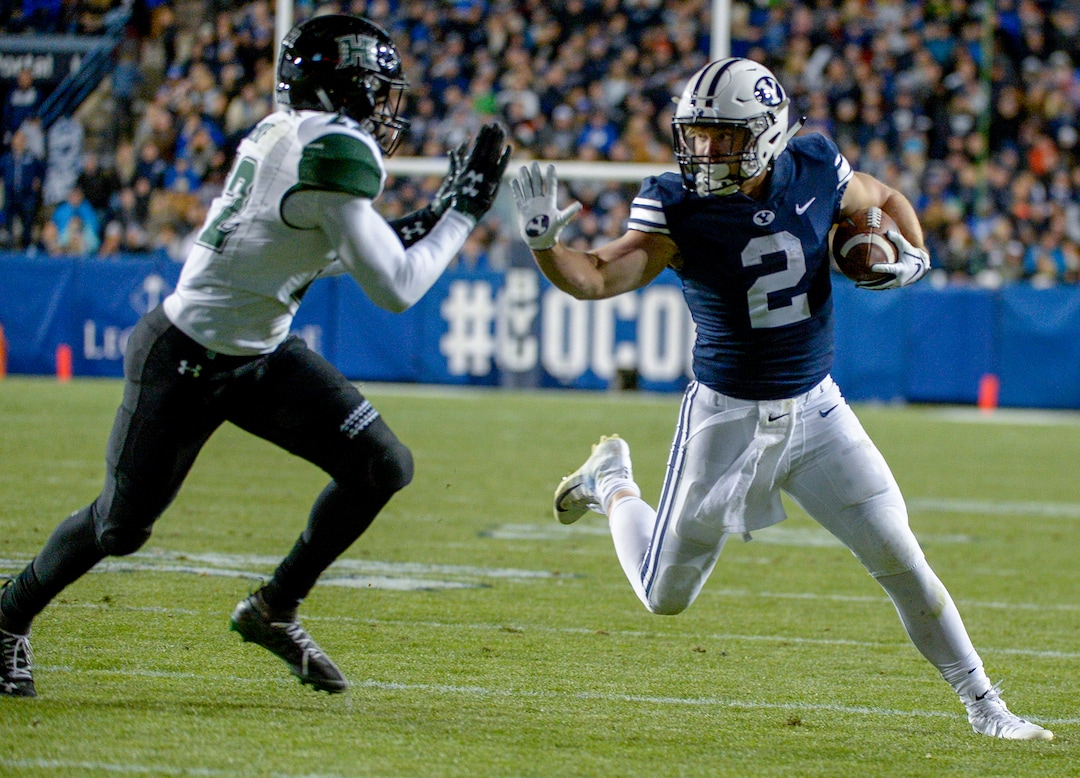 Leah Hogsten  |  The Salt Lake Tribune Brigham Young Cougars running back Matt Hadley (2) attempts to hold off Hawaii defensive back Ikem Okeke (22) as Brigham Young University hosts Hawaii at Lavell Edwards Stadium in Provo, Saturday Oct. 13, 2018. BYU defeated Hawaii 49-23.