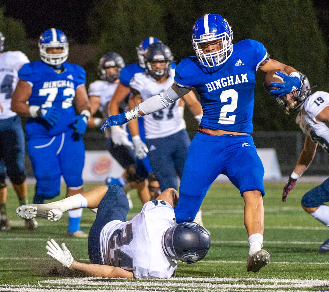 (Rick Egan  |  The Salt Lake Tribune)     Trevor Ogden grabs running back Saia Lomu as he  runs the ball for Bingham, in prep action between the Bingham Miners and the Corner Canyon Chargers, at Bingham High onFriday, Aug. 28, 2020.