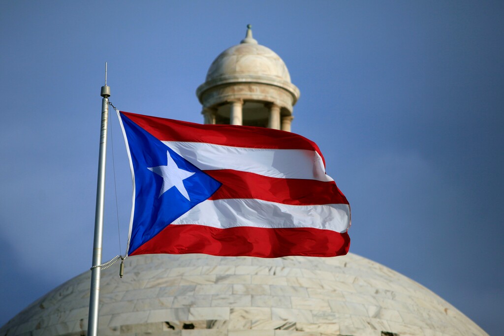 In this July 29, file 2015 photo, the Puerto Rican flag flies in front of Puerto Rico's Capitol as in San Juan, Puerto Rico. (AP Photo/Ricardo Arduengo, File)