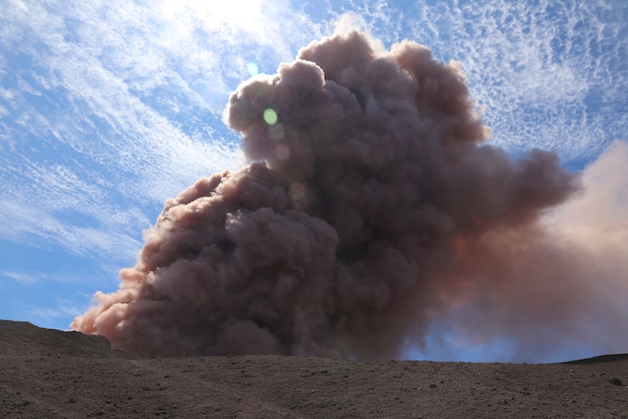 In this photo released by U.S. Geological Survey, a plume of ash rises from the Puu Oo vent on Hawaii's Kilaueaa Volcano after a magnitude 5.0 earthquake, Thursday, May 3, 2018 in Hawaii Volcanoes National Park. Hawaii's Kilauea volcano erupted Thursday, sending lava shooting into the air in a residential neighborhood and prompting mandatory evacuation orders for nearby homes. Hawaii County said steam and lava poured out of a crack in Leilani Estates, which is near the town of Pahoa on the Big Island. (U.S. Geological Survey via AP)